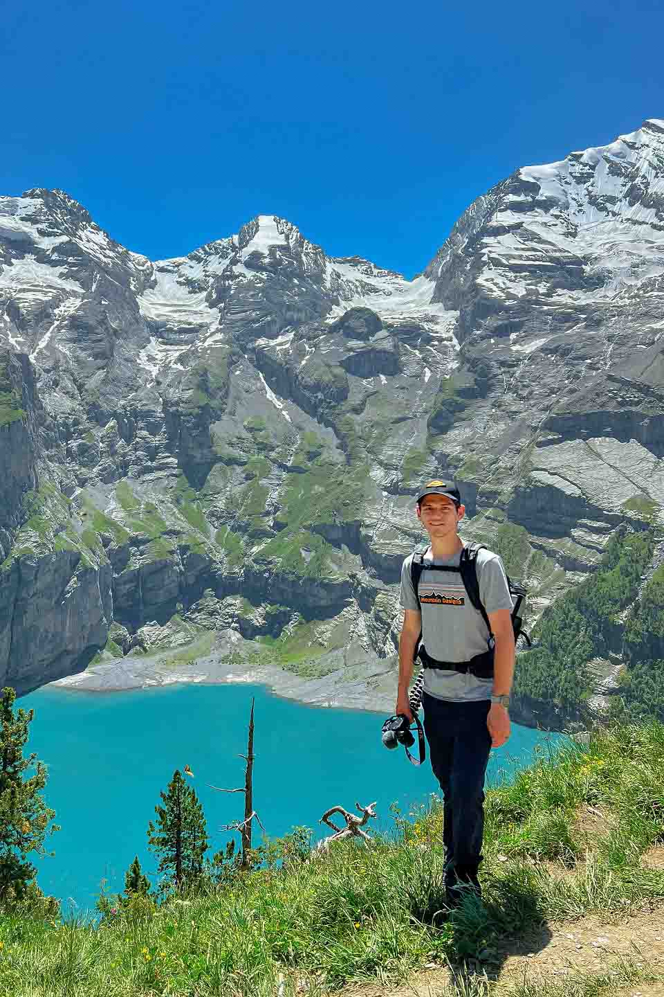 Zach posing with the mountains and Lake Oeschinen below