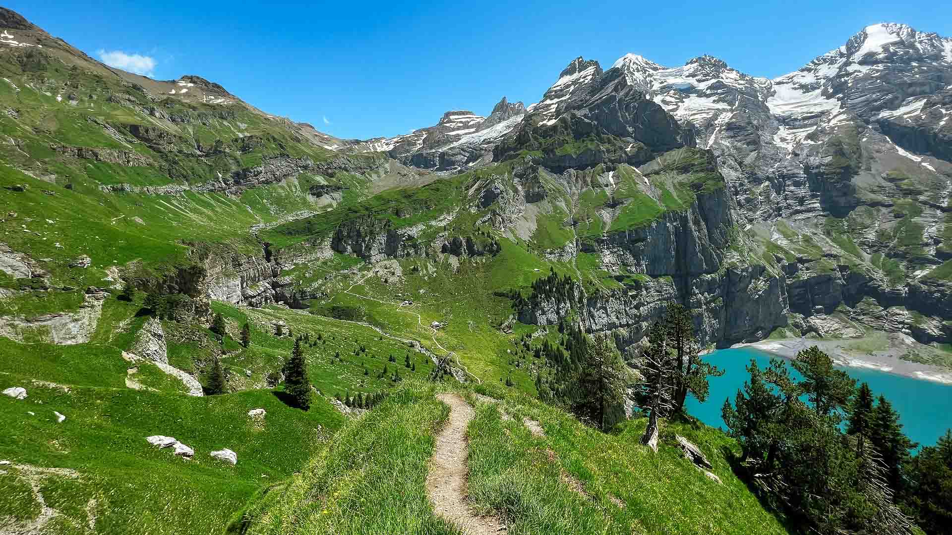 View of the hiking trail contrasing with Lake Oeschinen below