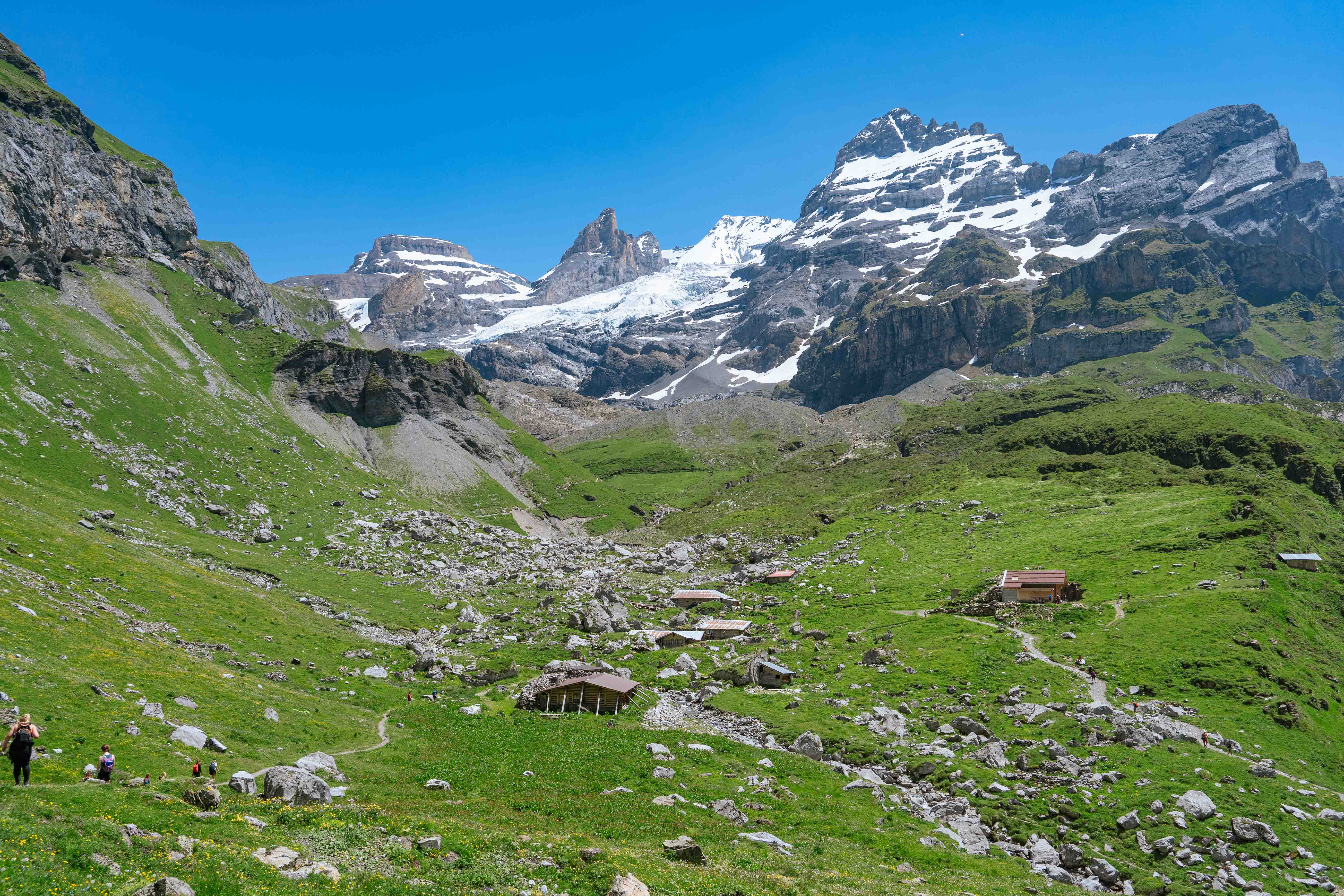 View of the hiking trail ascent and snow-topped surrounding mountains