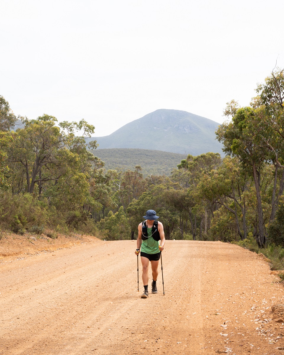 Jake walking on a road with Tread Carbon Trekking Poles