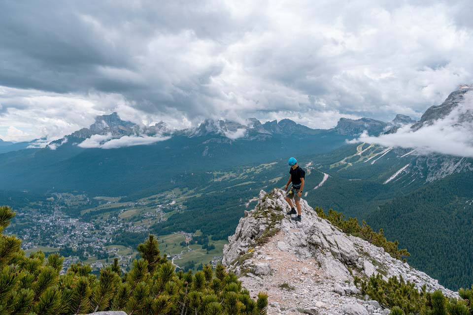 Zack Bostock on a rock ledge 3/4 of the way to the summit